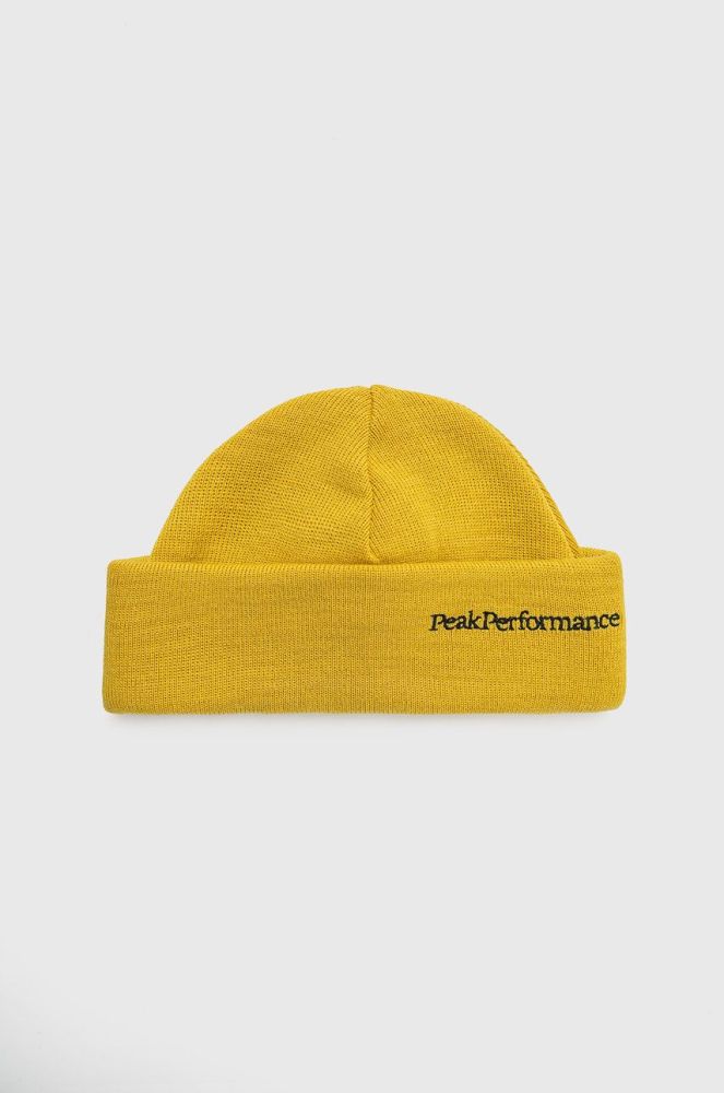 Вовняна шапка Peak Performance колір жовтий з тонкого трикотажу вовна