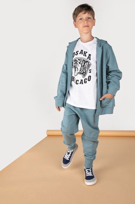 Дитячі спортивні штани Coccodrillo колір бірюзовий однотонні