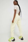 Спортивні штани Champion жіночі колір жовтий з аплікацією