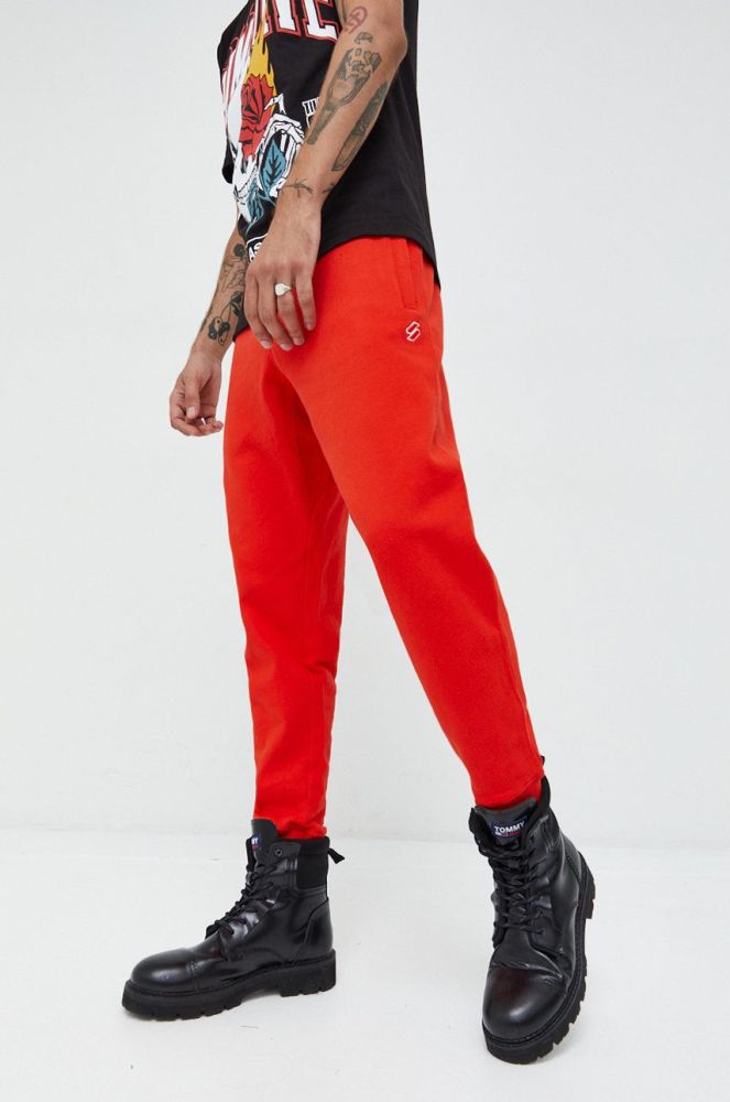 Бавовняні спортивні штани Superdry чоловічі колір червоний однотонні