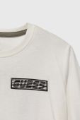 Дитячий бавовняний лонгслів Guess колір білий з принтом (3588085)