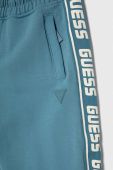 Дитячі спортивні штани Guess з принтом колір блакитний
