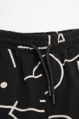 Дитячі бавовняні штани Coccodrillo колір чорний візерунок (3474503)