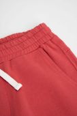 Дитячі бавовняні штани Coccodrillo колір бордовий однотонні (3495632)