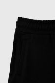 Дитячі бавовняні штани Guess колір чорний з аплікацією (3602670)
