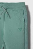 Дитячі спортивні штани Guess колір бірюзовий однотонні