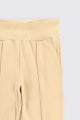 Дитячі бавовняні штани Coccodrillo колір бежевий однотонні (3642236)
