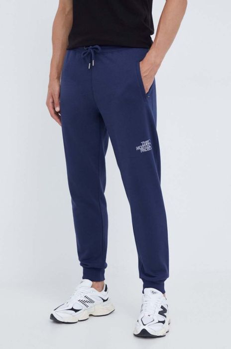 Бавовняні спортивні штани The North Face колір синій однотонні