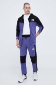 Бавовняні спортивні штани The North Face колір фіолетовий візерунок