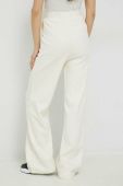 Бавовняні спортивні штани Fila колір бежевий однотонні (3036311)