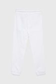Дитячі бавовняні штани Guess колір білий однотонні