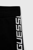 Дитячі бавовняні штани Guess колір чорний з принтом (2902497)