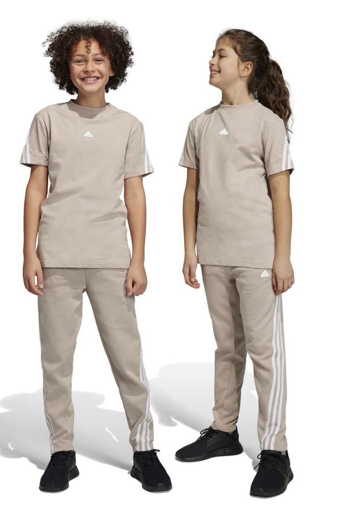 Дитячі спортивні штани adidas U FI 3S колір бежевий з аплікацією
