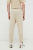 Бавовняні спортивні штани Fila колір бежевий однотонні (3023086)