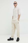 Бавовняні спортивні штани Tommy Jeans чоловічі колір бежевий однотонні