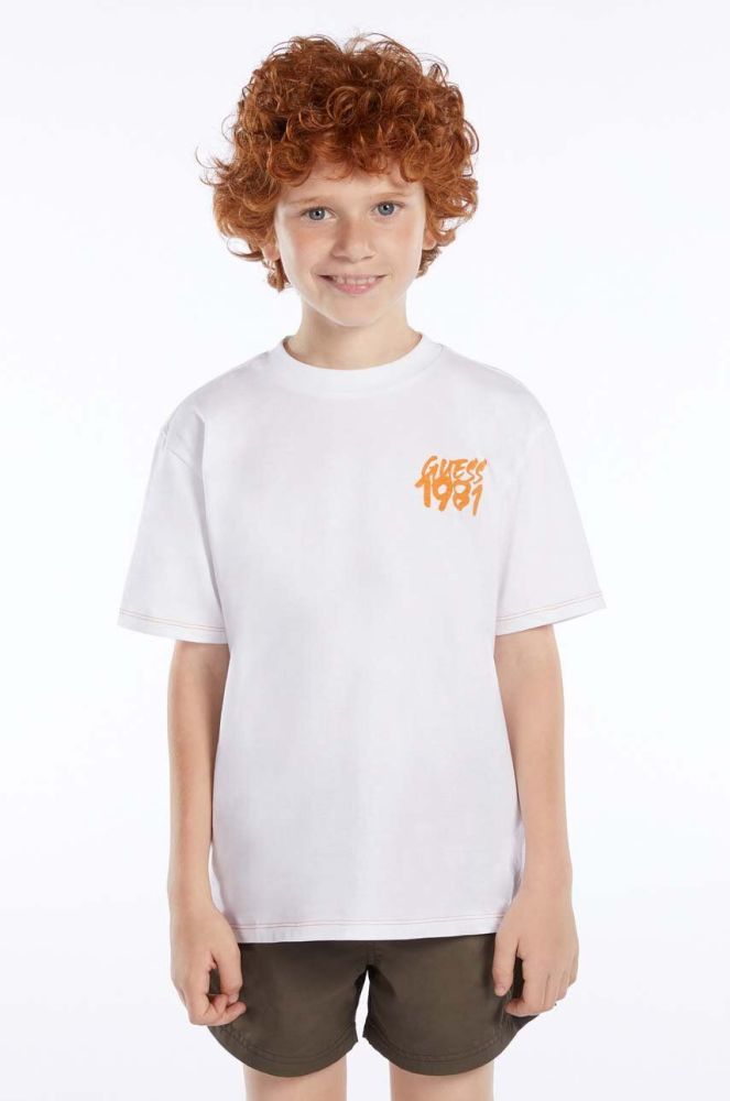 Дитяча бавовняна футболка Guess колір білий з принтом (3015514)